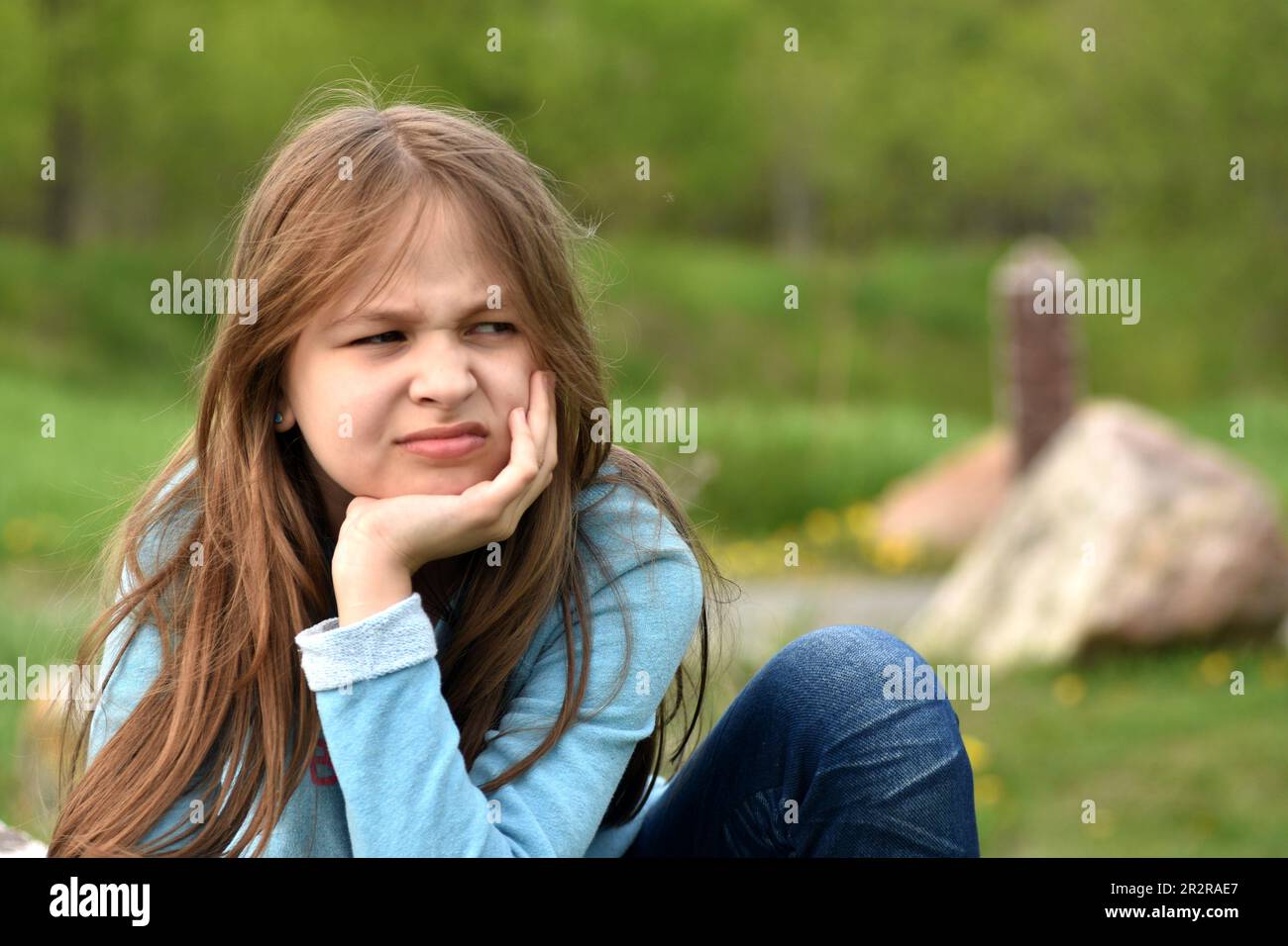Beautiful young long hair girl in causal clothes posing outdoors Stock Photo
