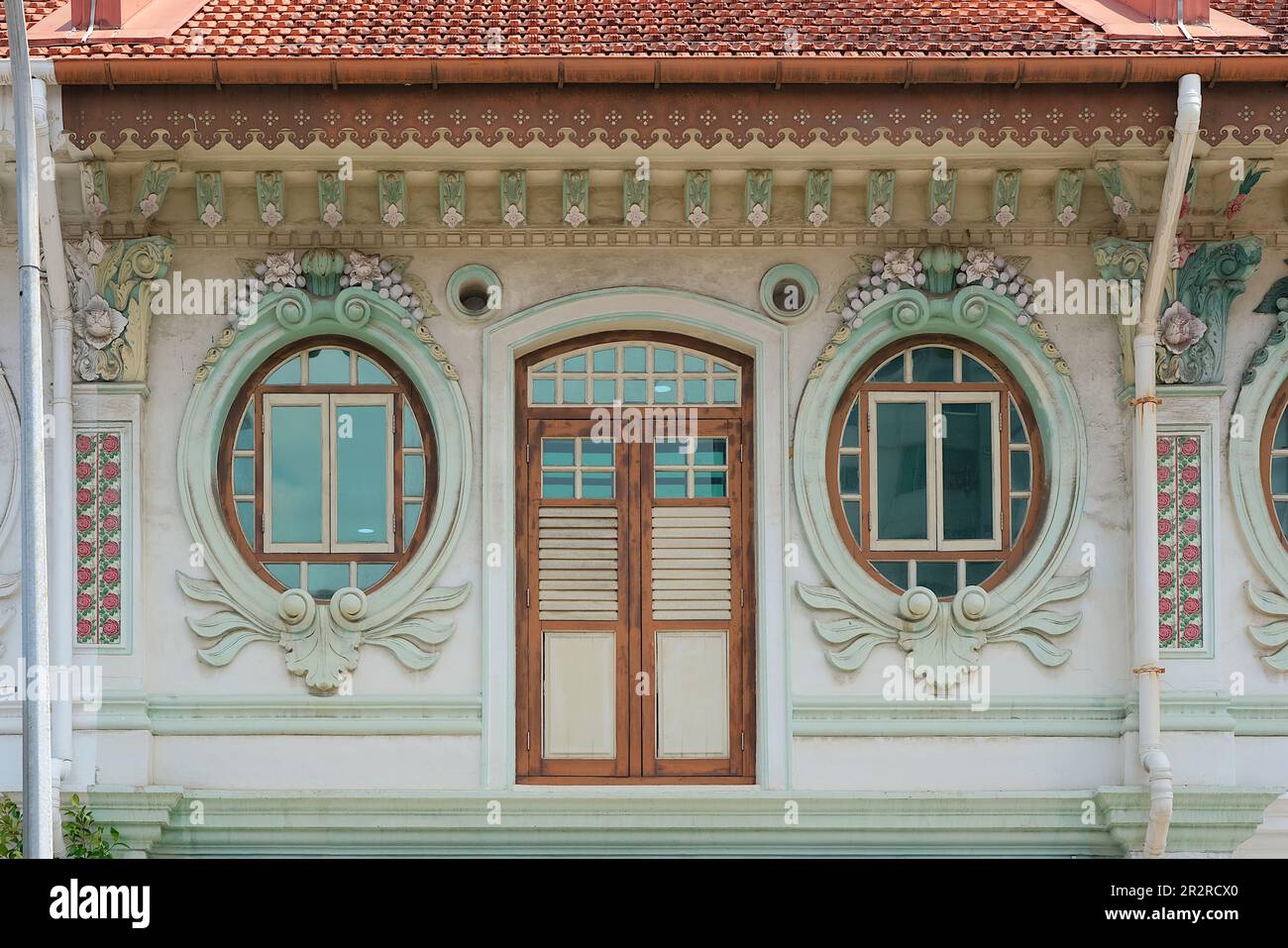 Ornate Straits Chinese or Peranakan shophouse exterior with brown ...