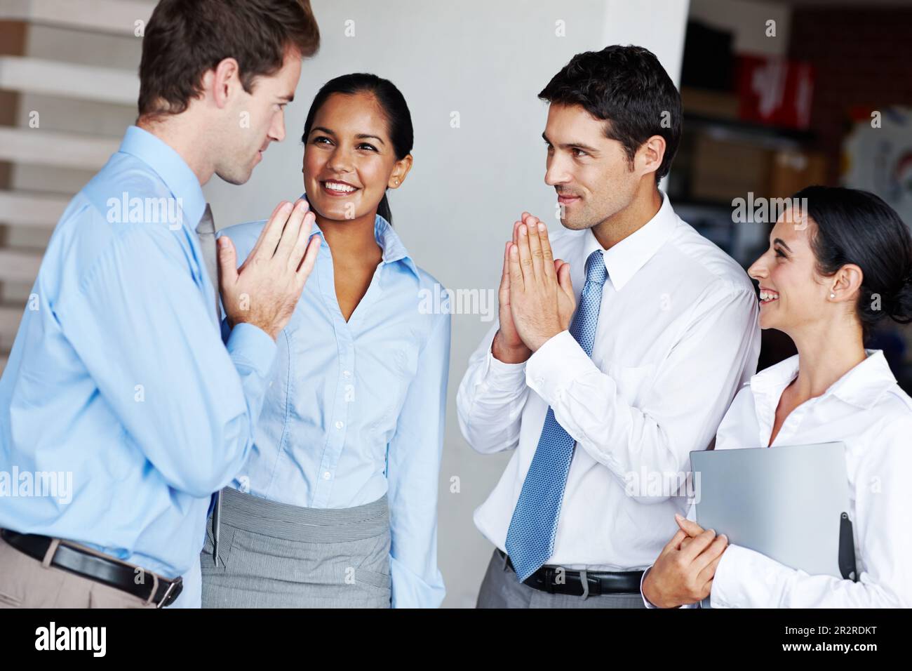 Zen-like respect. Two businessmen paying respects to one another by bowing with hands together. Stock Photo