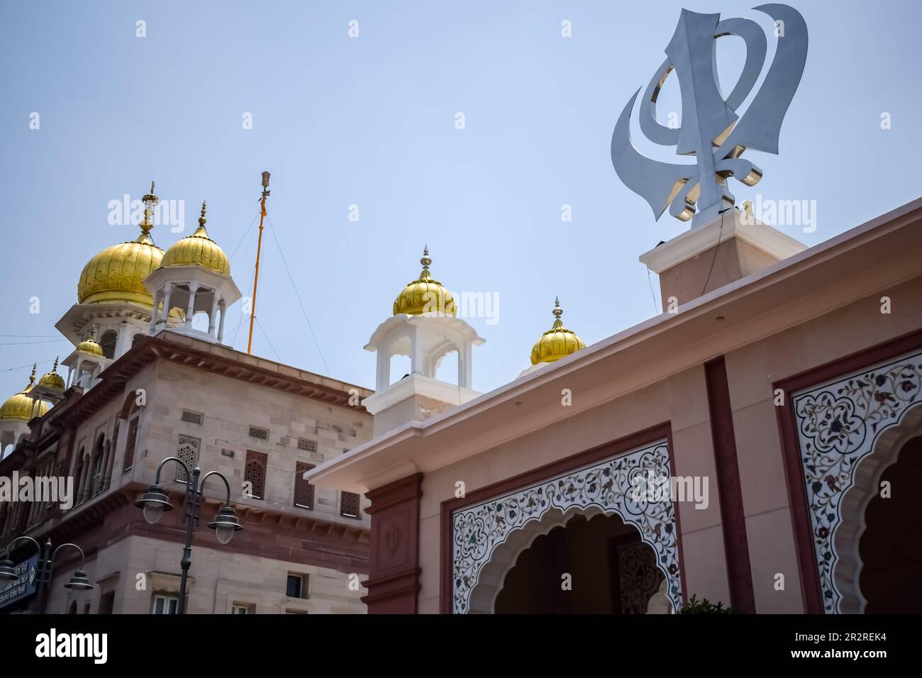 Khanda Sikh holy religious symbol at gurudwara entrance with bright