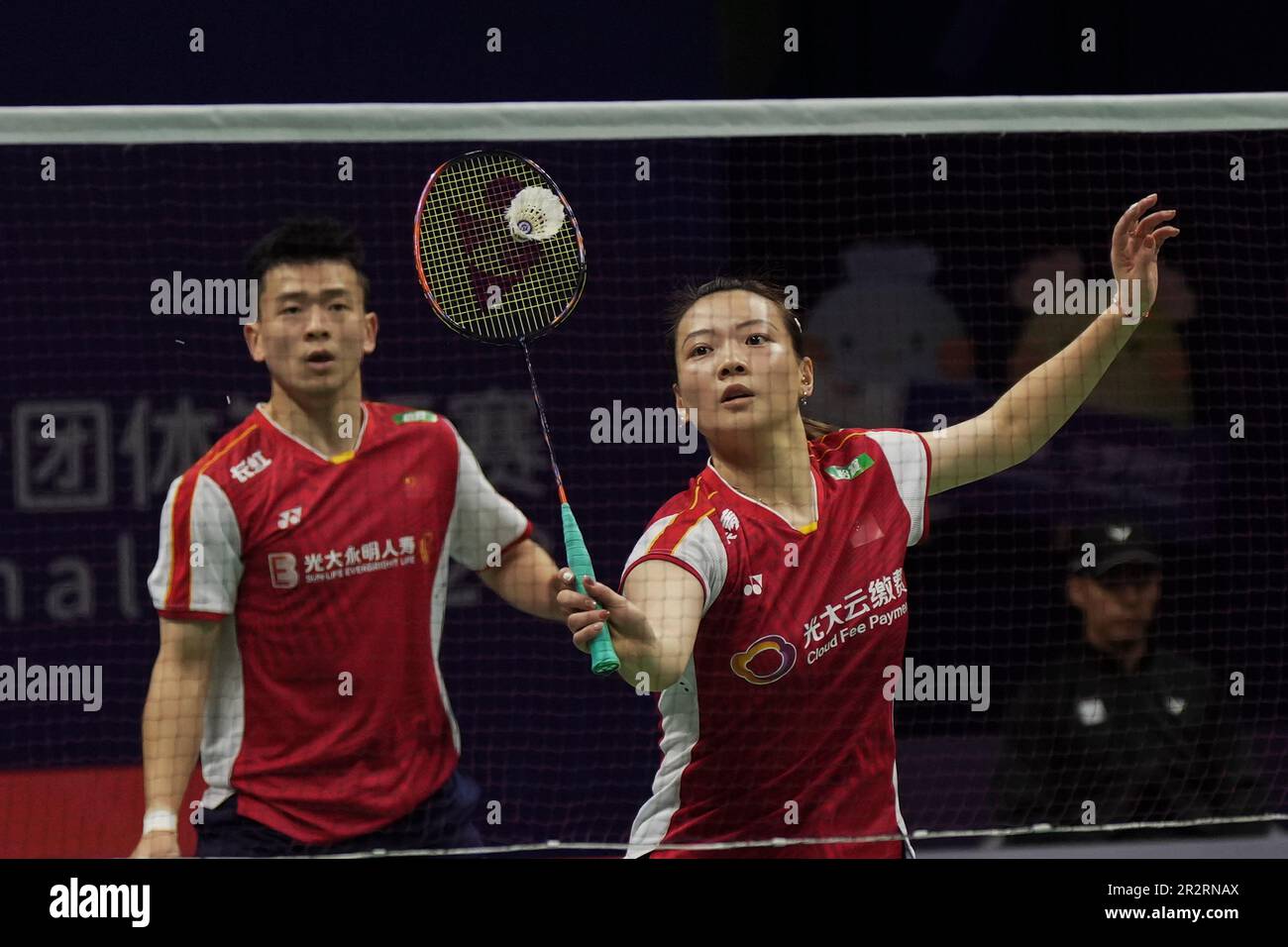 Huang Yaqiong of China returns a shot with teammate Zheng Siwei during their mixed doubles badminton final match against Seo Seung Jae and Chae Yu Jung of South Korea at the BWF