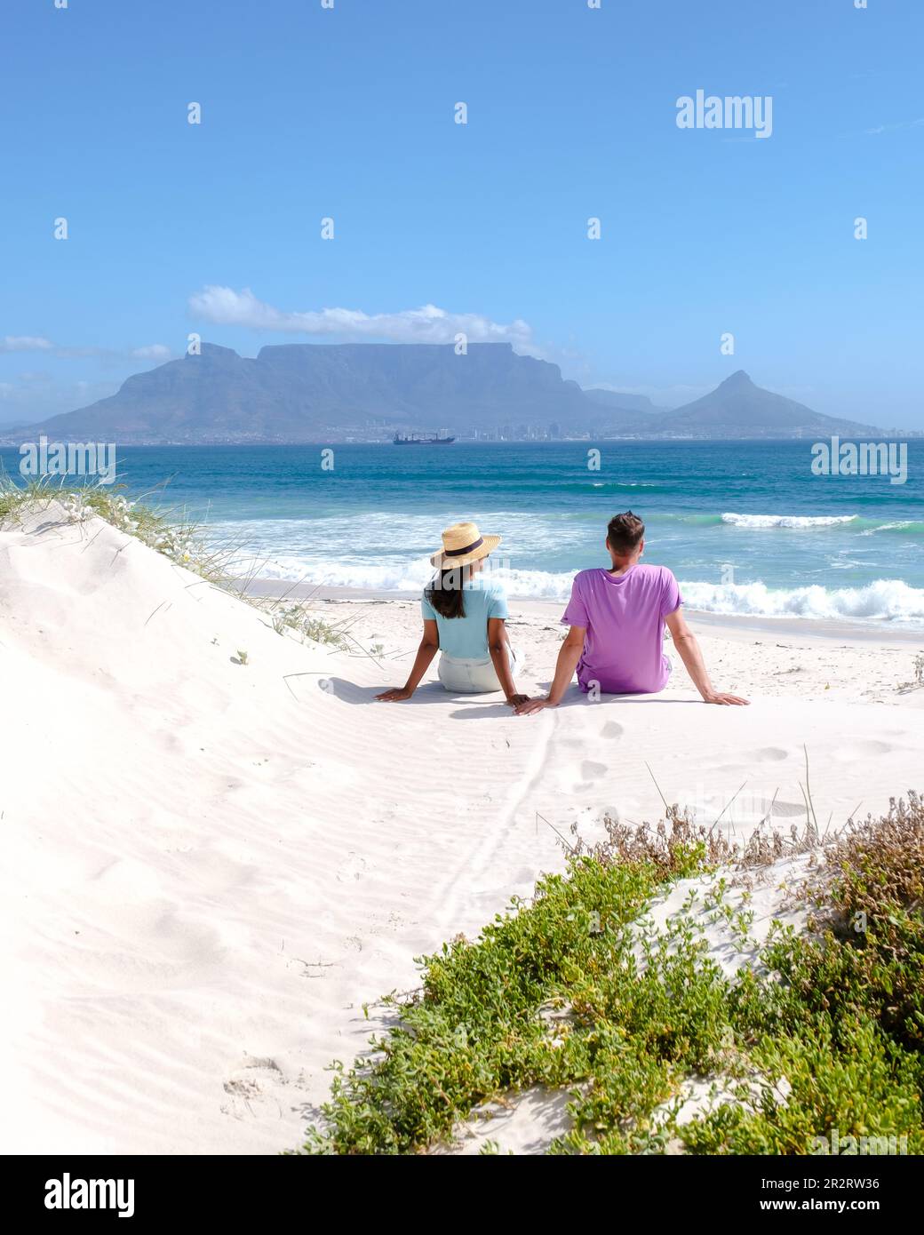 Bloubergstrand Cape Town South Africa on a bright summer day, couple on the beach, men and women chilling on the beach during vacation in Cape Town South Africa Stock Photo