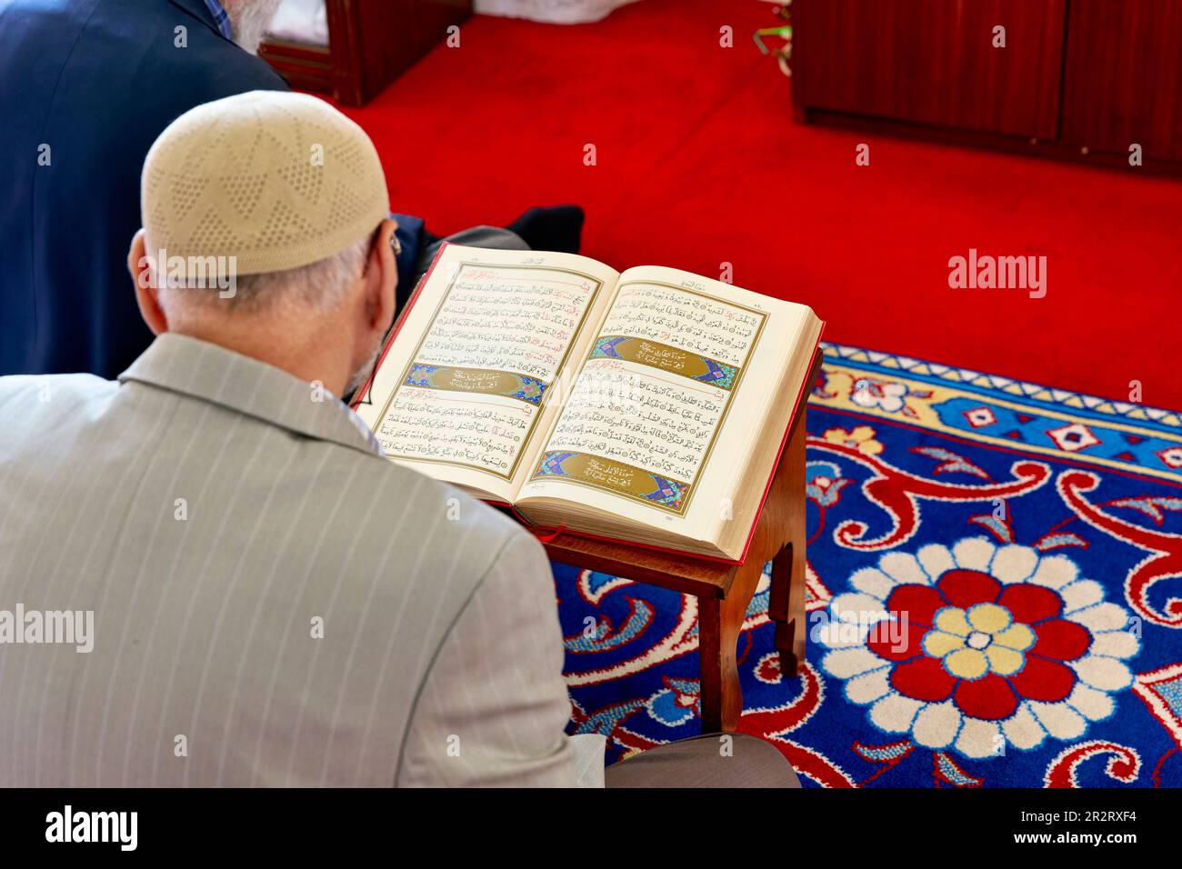 Istanbul Turkey. Muslim believer praying and reading Koran in the Fatih Mosque Stock Photo