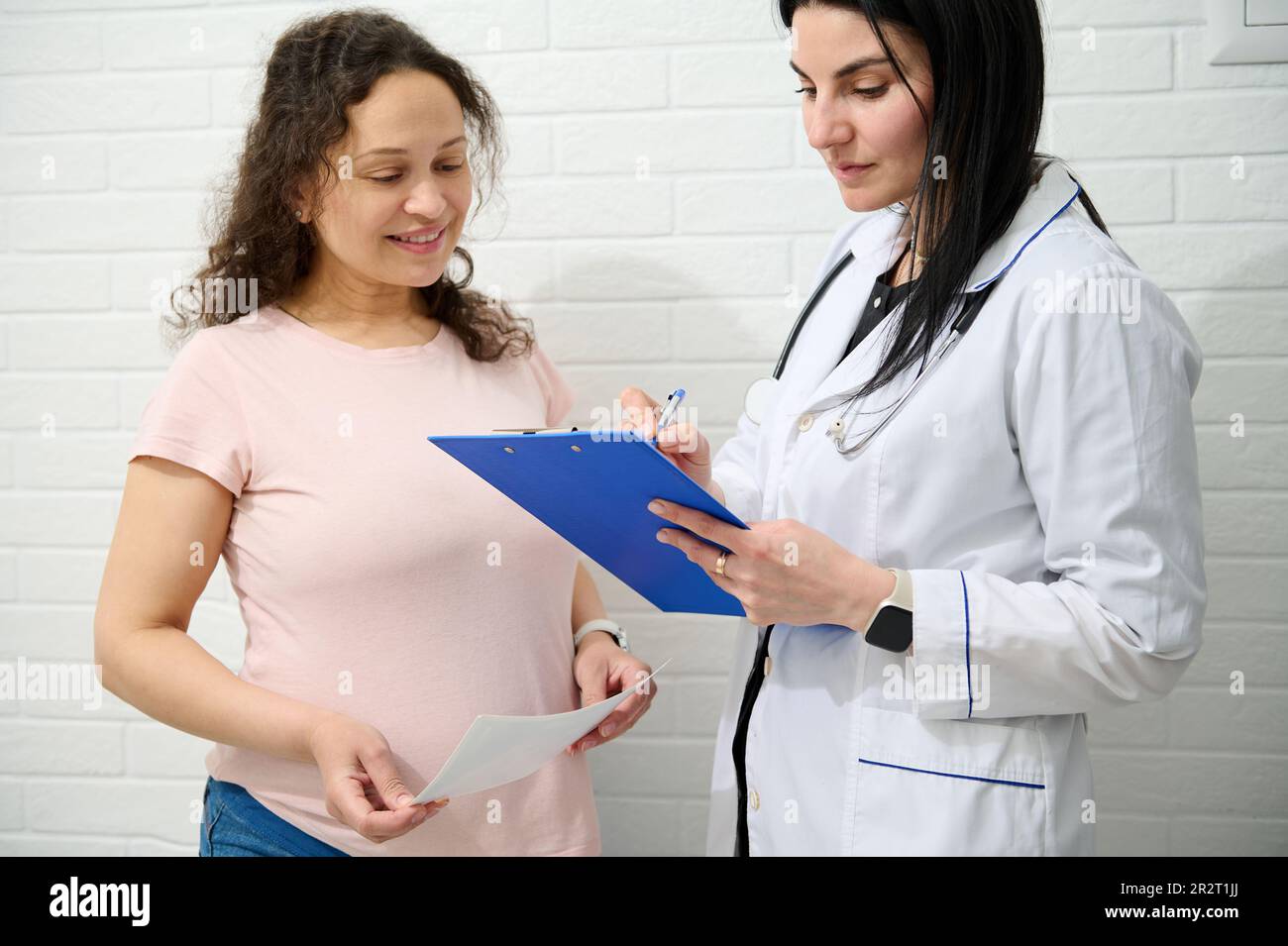 Multi ethnic pregnant woman at obstetrician appointment Stock Photo Alamy