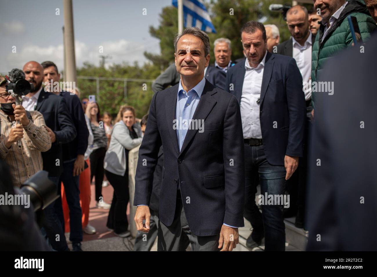 Athen, Greece. 21st May, 2023. Kyriakos Mitsotakis, Greek prime minister and leader of the conservative Nea Dimokratia (ND) party, takes a selfie with a voter after casting his ballot at a polling station in the Kifisia district. These are the first Greek parliamentary elections since the country's economy ceased to be subject to strict monitoring and control by the international lenders who provided bailout money during the nearly decade-long financial crisis. Credit: Socrates Baltagiannis/dpa/Alamy Live News Stock Photo