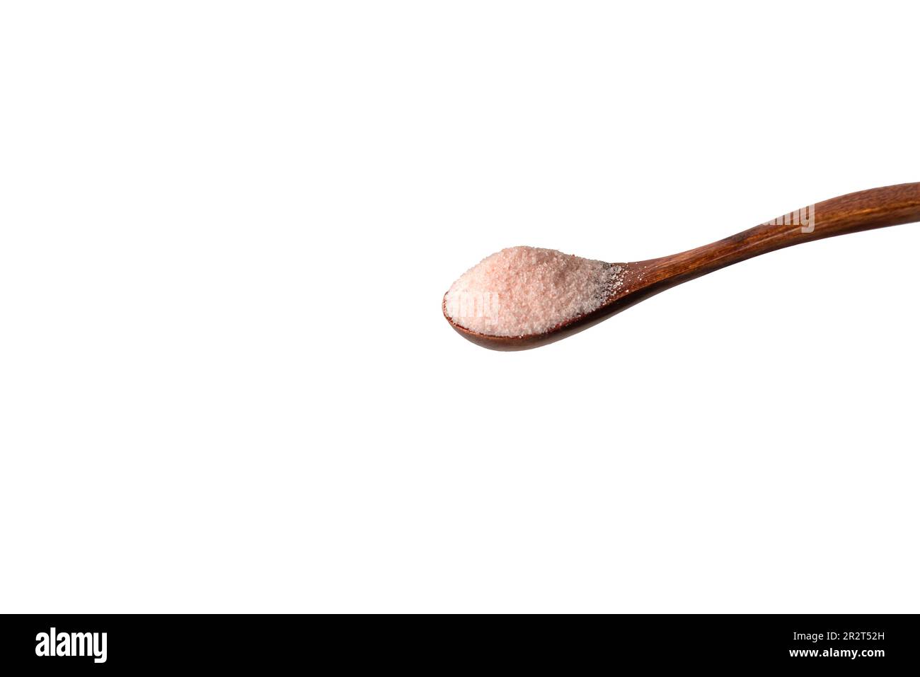 Wooden spoon with Himalayan pink salt. Stock Photo
