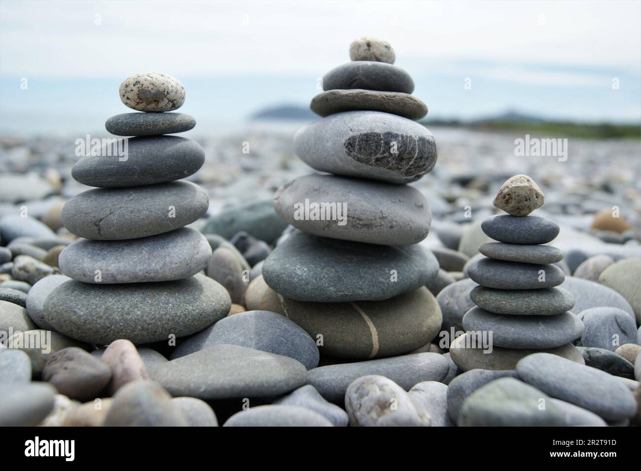 Three Zen towers on a stony beach. Towers made of pebbles. Stock Photo