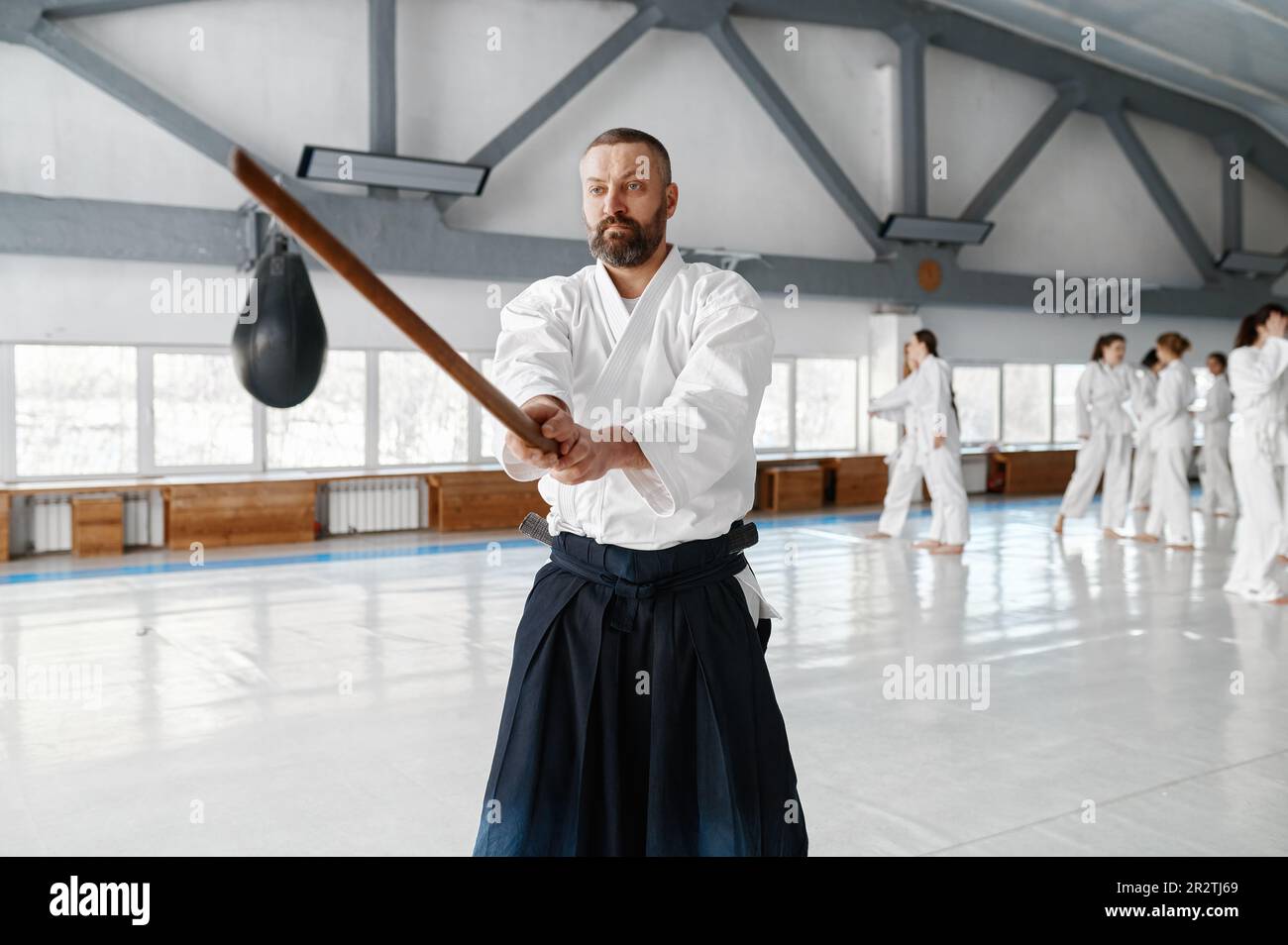 Portrait of aikido sensei master with wooden sword at group training Stock Photo