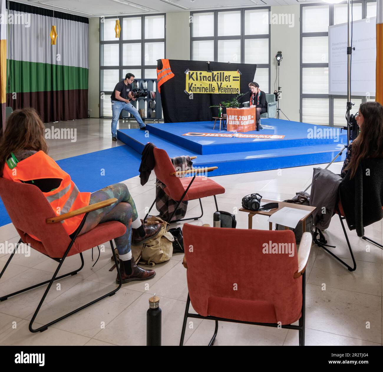 Hamburg, Germany. 21st May, 2023. A woman reads texts about non-violent resistance at a permanent reading in the foyer of the Galerie der Gegenwart of the Hamburger Kunsthalle as part of a nationwide art performance by the activist group Letzte Generation. Credit: Markus Scholz/dpa/Alamy Live News Stock Photo