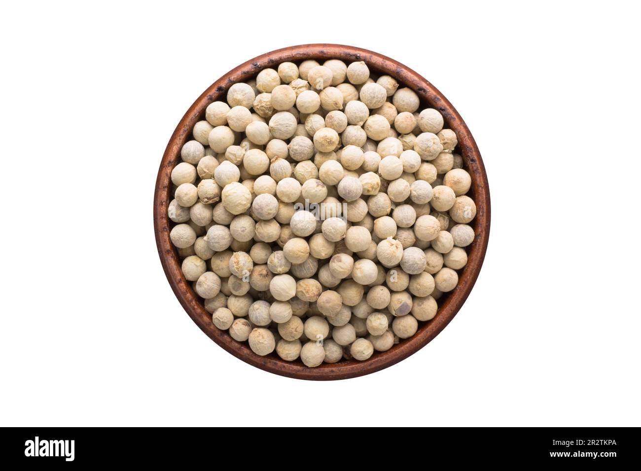 white pepper seasoning in a wooden bowl, top view. spice isolated on white Stock Photo