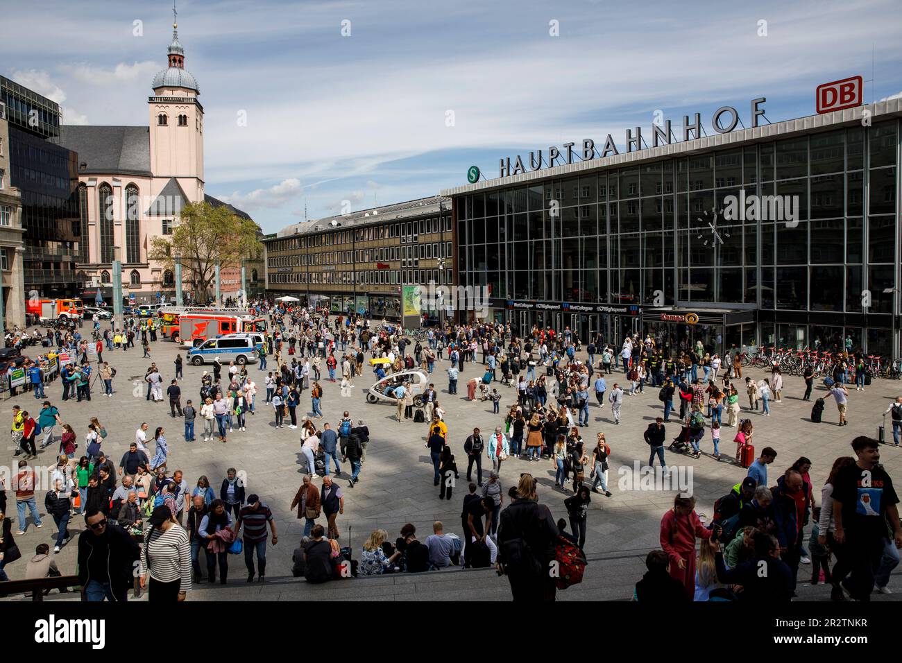 many people in front of the central station, church St. Mariae Himmelfahrt, Cologne, Germany. viele Menschen vor dem Hauptbahnhof, Kirche St. Mariae H Stock Photo