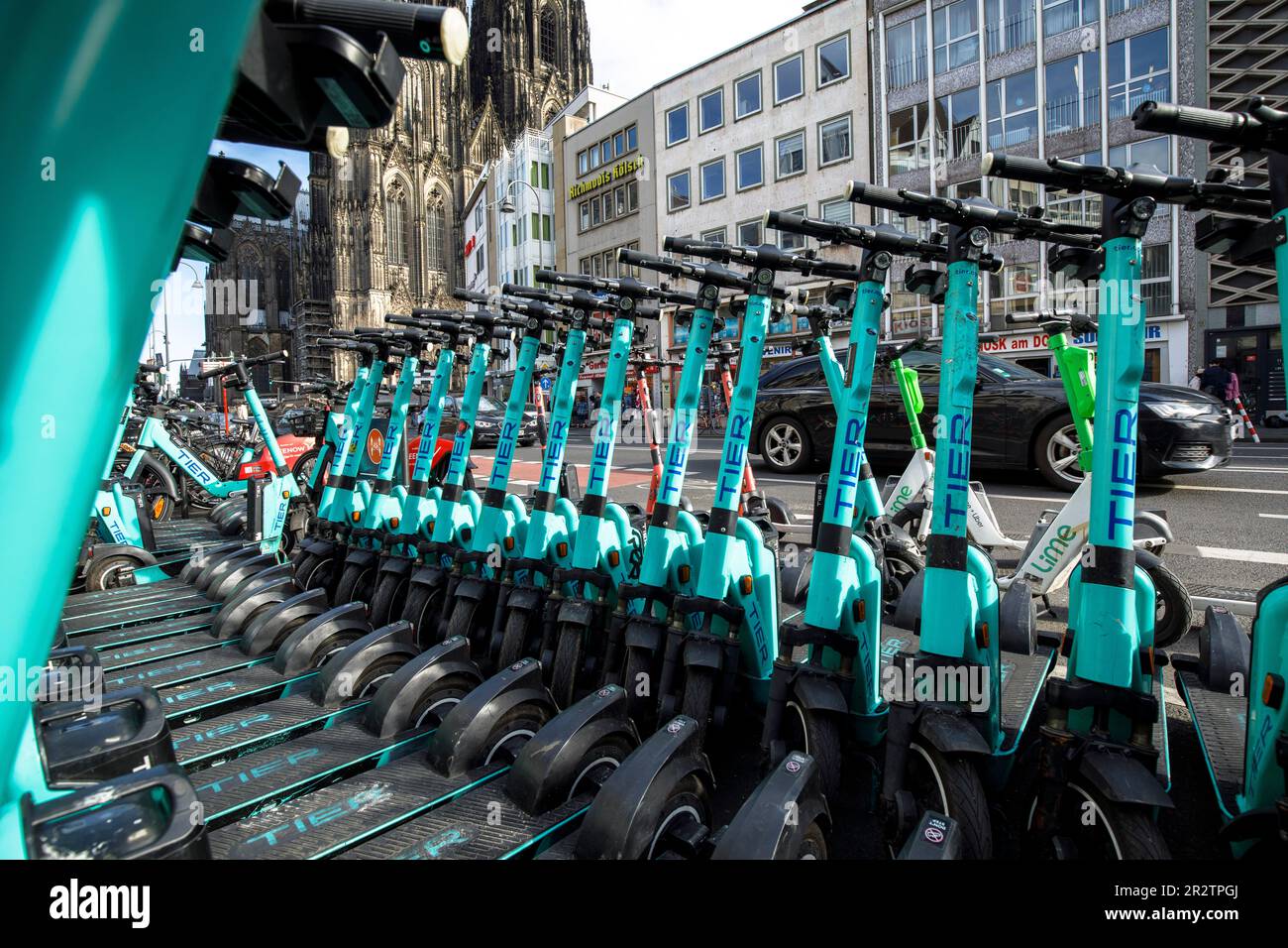 Tier electric scooters for rent are parked on Komoedien street near the