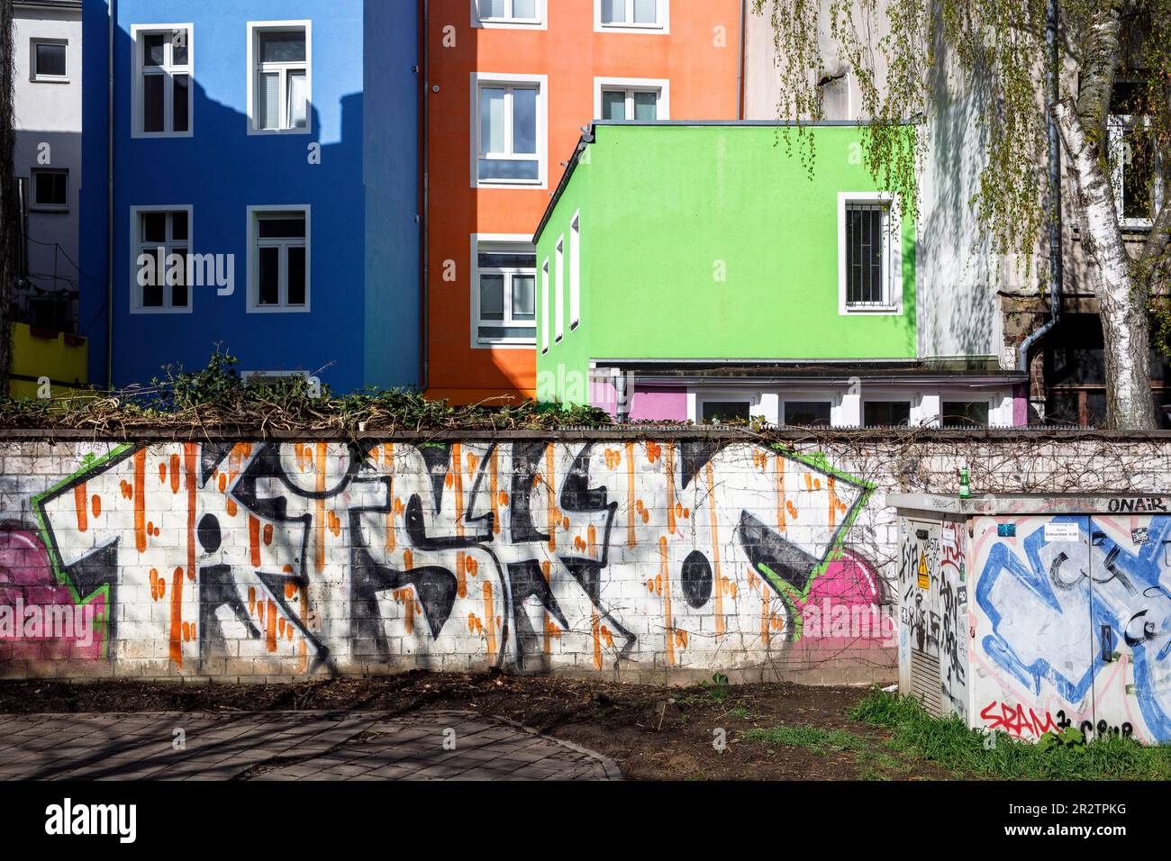 wall with graffiti and colorful house facades in Eigelstein quarter ...