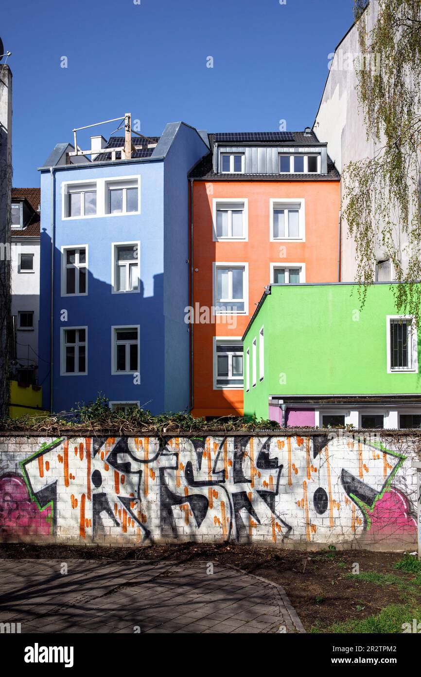 wall with graffiti and colorful house facades in Eigelstein quarter ...