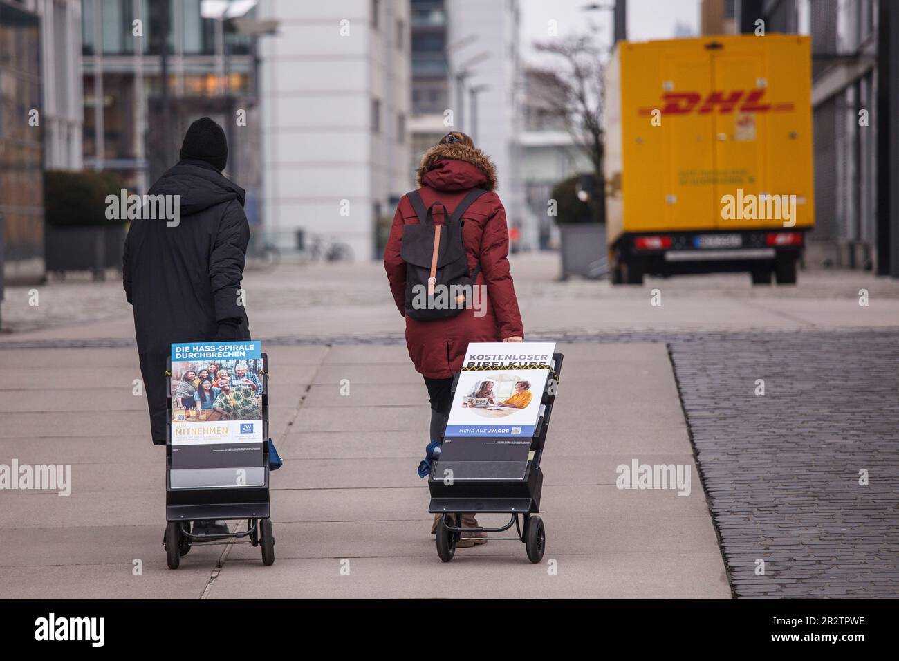 two Jehovah's Witnesses with brochures on trolleys during street mission in Rheinau harbour, Cologne, Germany.   zwei Zeugen Jehovas mit Schriften auf Stock Photo