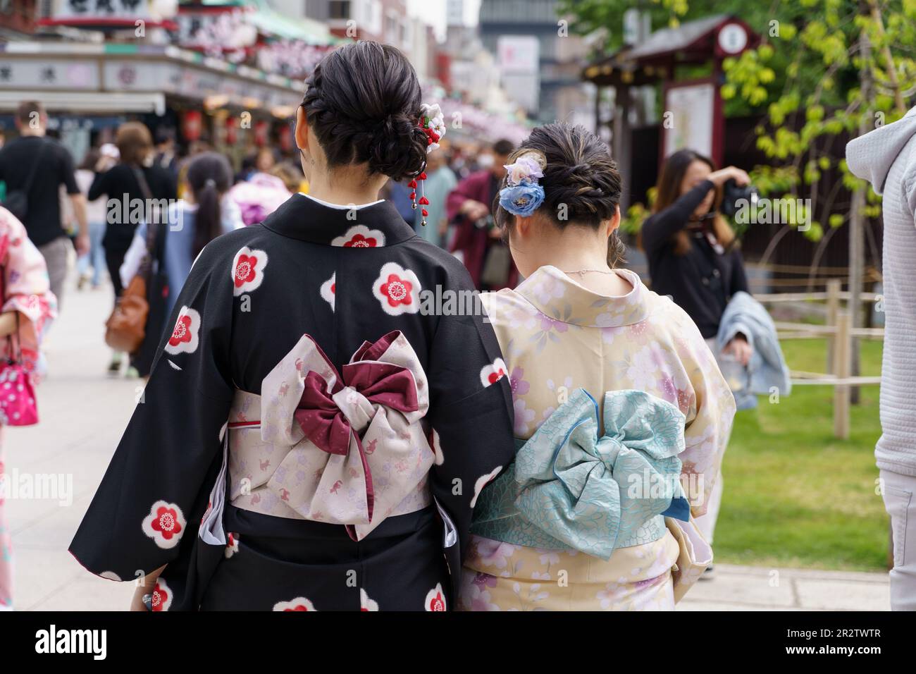 Young girl wearing Japanese kimono standing in front of Sensoji Temple