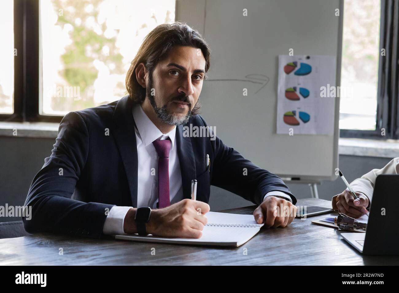 Handsome middle eastern man CEO manager singing papers Stock Photo