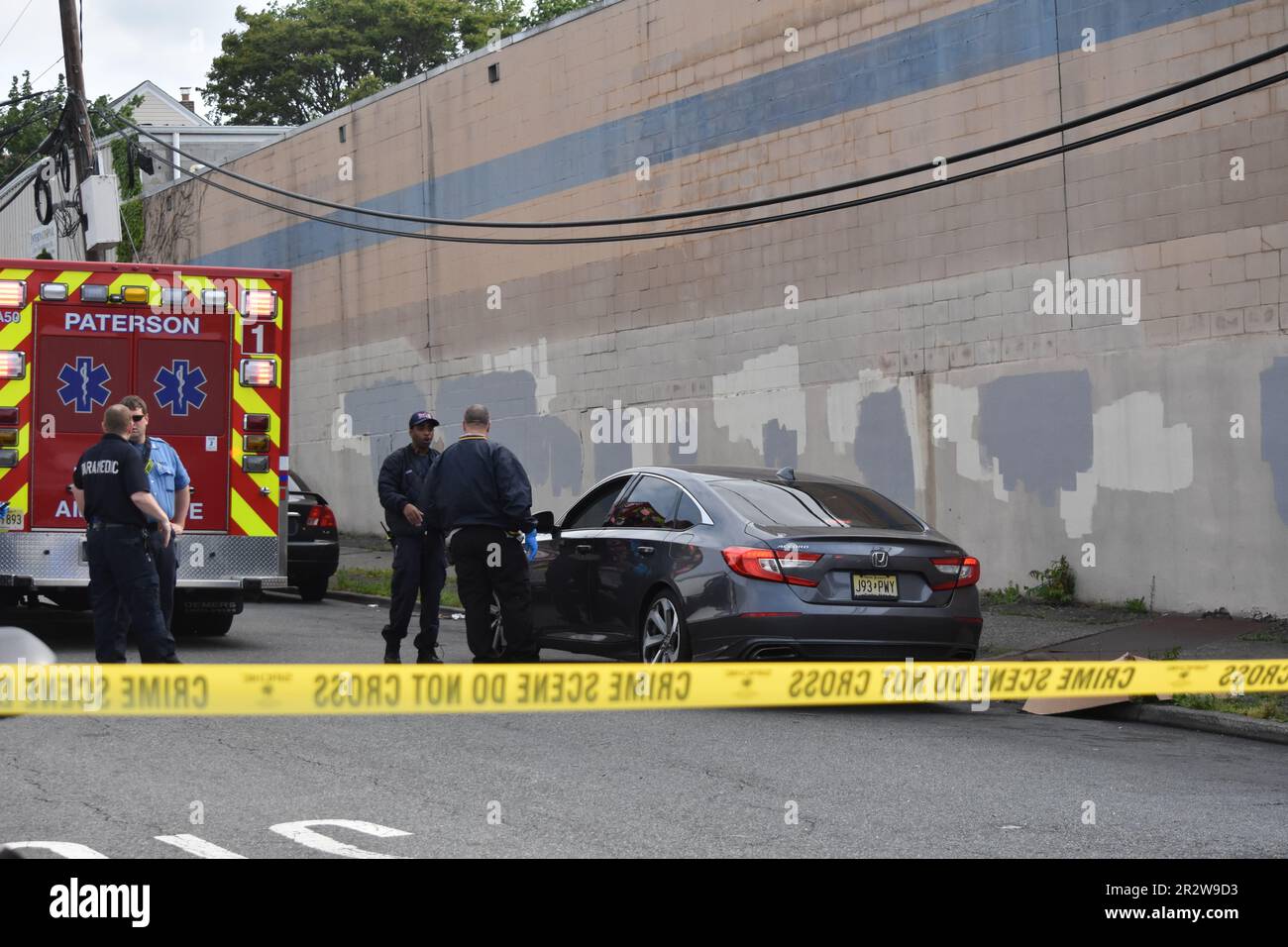 Paterson, United States. 21st May, 2023. EMS and police officers at the