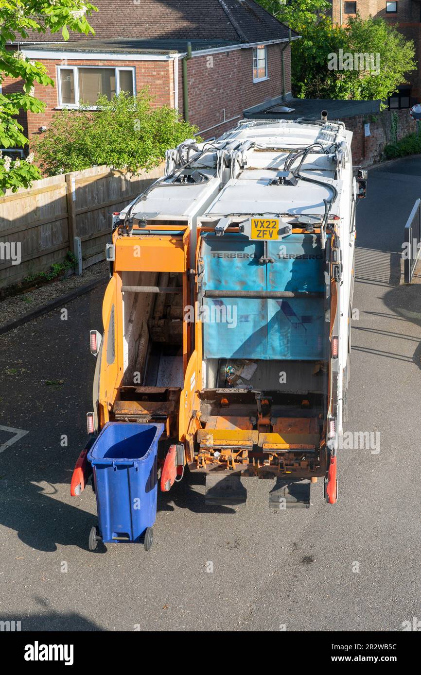A refuse collection vehicle emptying bins in a housing estate in