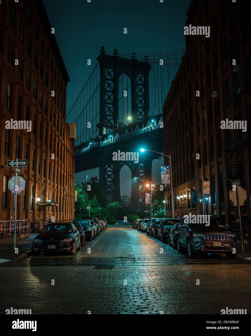 Cobblestone street and the Manhattan Bridge at night, Dumbo, Brooklyn, New York Stock Photo