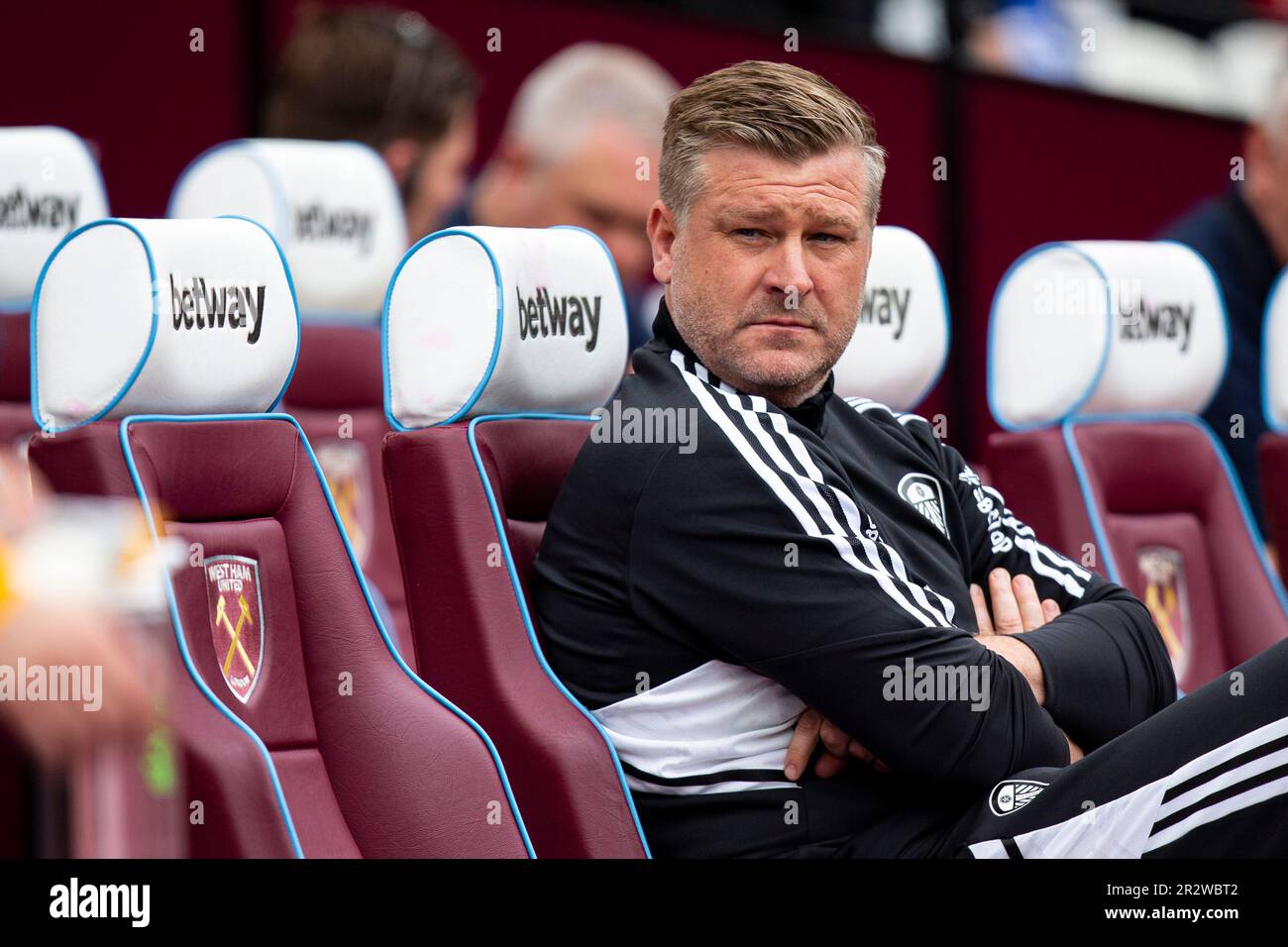 London, UK. 21st May, 2023. Leeds United coach Karl Robinson in the dugout ahead of kick off. Premier League match, West Ham Utd v Leeds Utd at the London Stadium, Queen Elizabeth Olympic Park in London on Sunday 21st May 2023 . this image may only be used for Editorial purposes. Editorial use only pic by Lewis Mitchell/Andrew Orchard sports photography/Alamy Live news Credit: Andrew Orchard sports photography/Alamy Live News Stock Photo