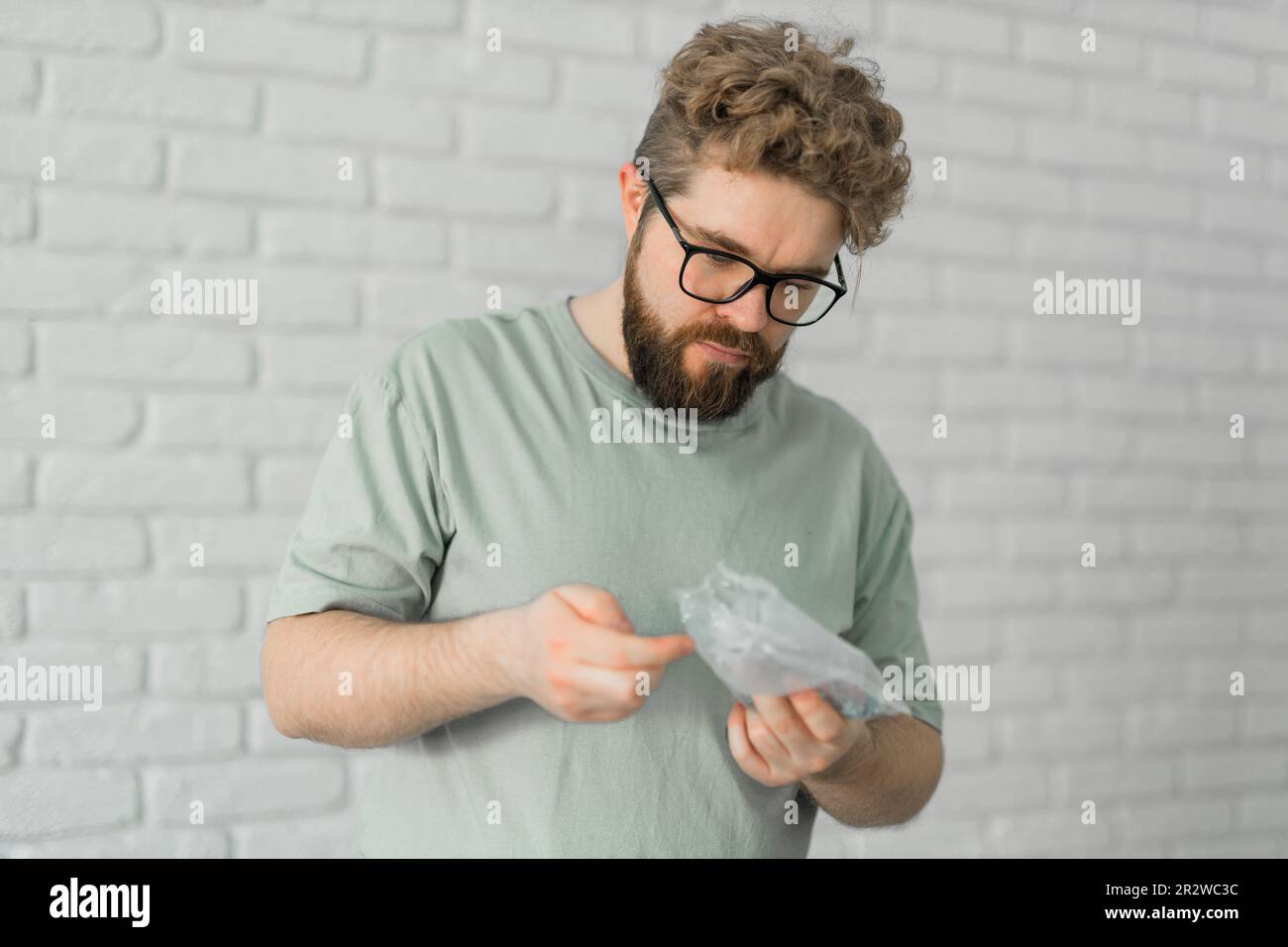 Man holding nails for furniture assembly nails Stock Photo - Alamy
