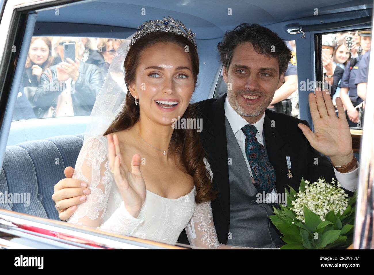 MUNICH, Germany - 20. MAY 2023: the bride, Sophie-Alexandra Princess of Bavaria with a lily of the valley bouquet, in the historic BMW 505 looks on with the groom Prince Ludwig von Bayern, die Braut mit einem Maiglöckchen Blumenstrauß und Ihr Ehemann Prinz Ludwig von Bayern, Prince Ludwig von Bayern and his wife Sophie-Alexandra Princess of Bavaria got Married in the Theatiner Church, Prinz Ludwig is part of the Wittelsbacher dynasty . WITTELSBACHER HOCHZEIT, Royal Wedding in Munich on 20. May 2023, in Germany. Ludwig Prinz von Bayern und seine Frau Sophie-Alexandra Prinzessin von Bayern, Stock Photo