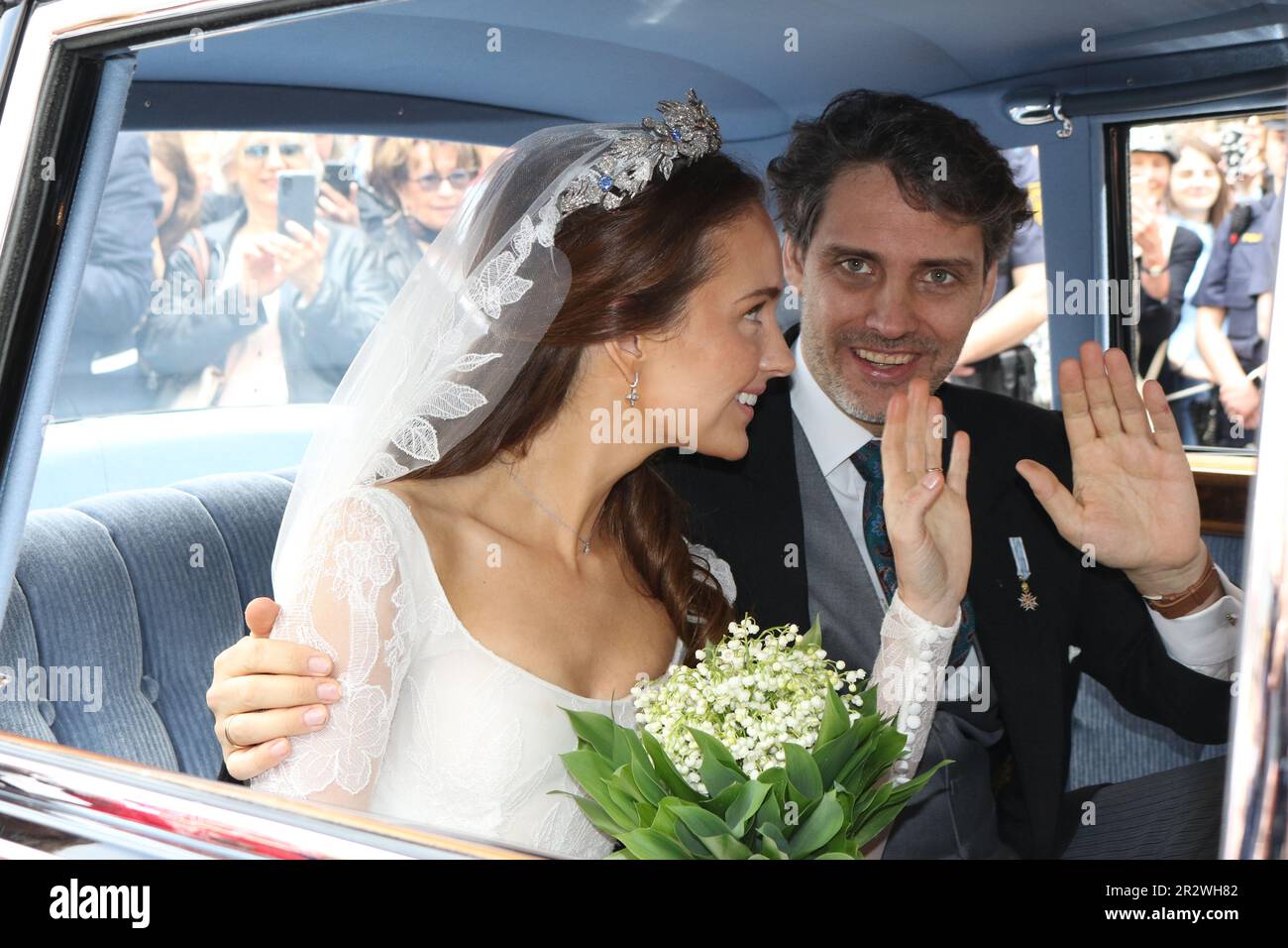 MUNICH, Germany - 20. MAY 2023: the bride, Sophie-Alexandra Princess of Bavaria with a lily of the valley bouquet, in the historic BMW 505 looks on with the groom Prince Ludwig von Bayern, die Braut mit einem Maiglöckchen Blumenstrauß und Ihr Ehemann Prinz Ludwig von Bayern, Prince Ludwig von Bayern and his wife Sophie-Alexandra Princess of Bavaria got Married in the Theatiner Church, Prinz Ludwig is part of the Wittelsbacher dynasty . WITTELSBACHER HOCHZEIT, Royal Wedding in Munich on 20. May 2023, in Germany. Ludwig Prinz von Bayern und seine Frau Sophie-Alexandra Prinzessin von Bayern, Stock Photo