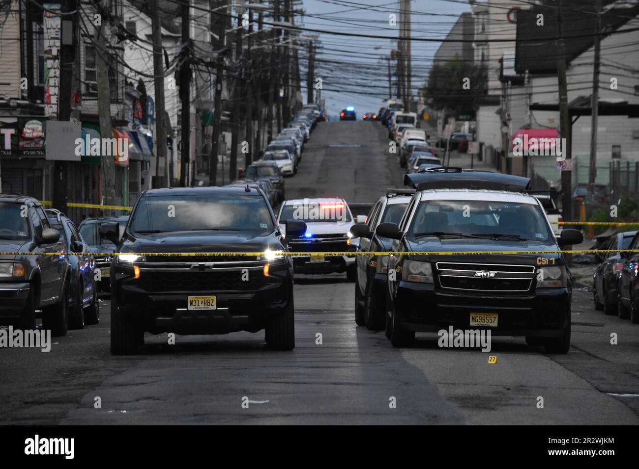 Evidence markers seen on the ground at the crime scene. Paterson police
