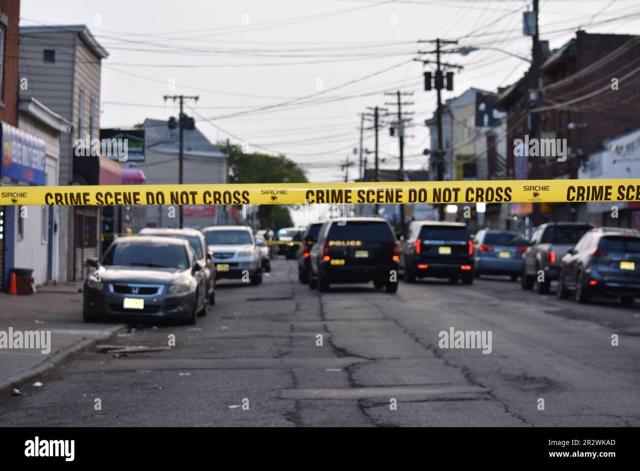 Crime scene tape blocks the area to pedestrians and vehicles where the shooting took place. Paterson police vehicles were staged at the crime scene securing the area. Multiple people were shot on River Street in Paterson, New Jersey Sunday morning around 2:30 AM Eastern Time. Crime Scene Investigation and Paterson police officers were on the scene gathering evidence from the area. Individuals who were shot were transported to the hospital by private cars. No official information was immediately available from the Paterson police. (Photo by Kyle Mazza/SOPA Images/Sipa USA) Stock Photo