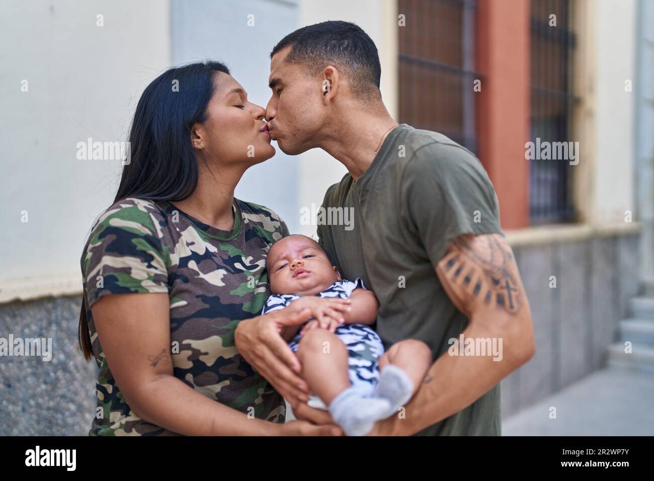 Hispanic family hugging each other and kissing at street Stock Photo ...