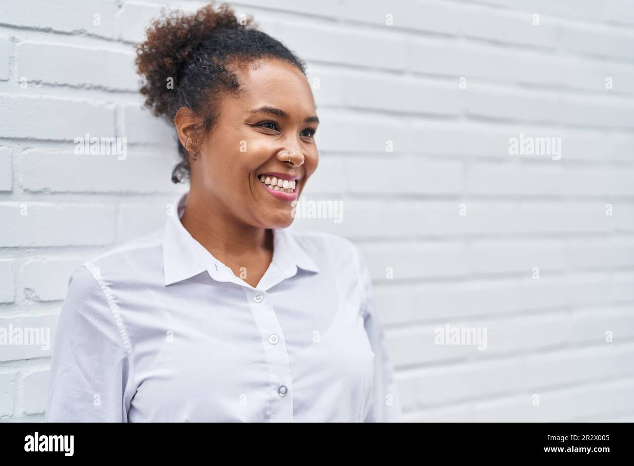 African american woman smiling confident looking to the side over ...
