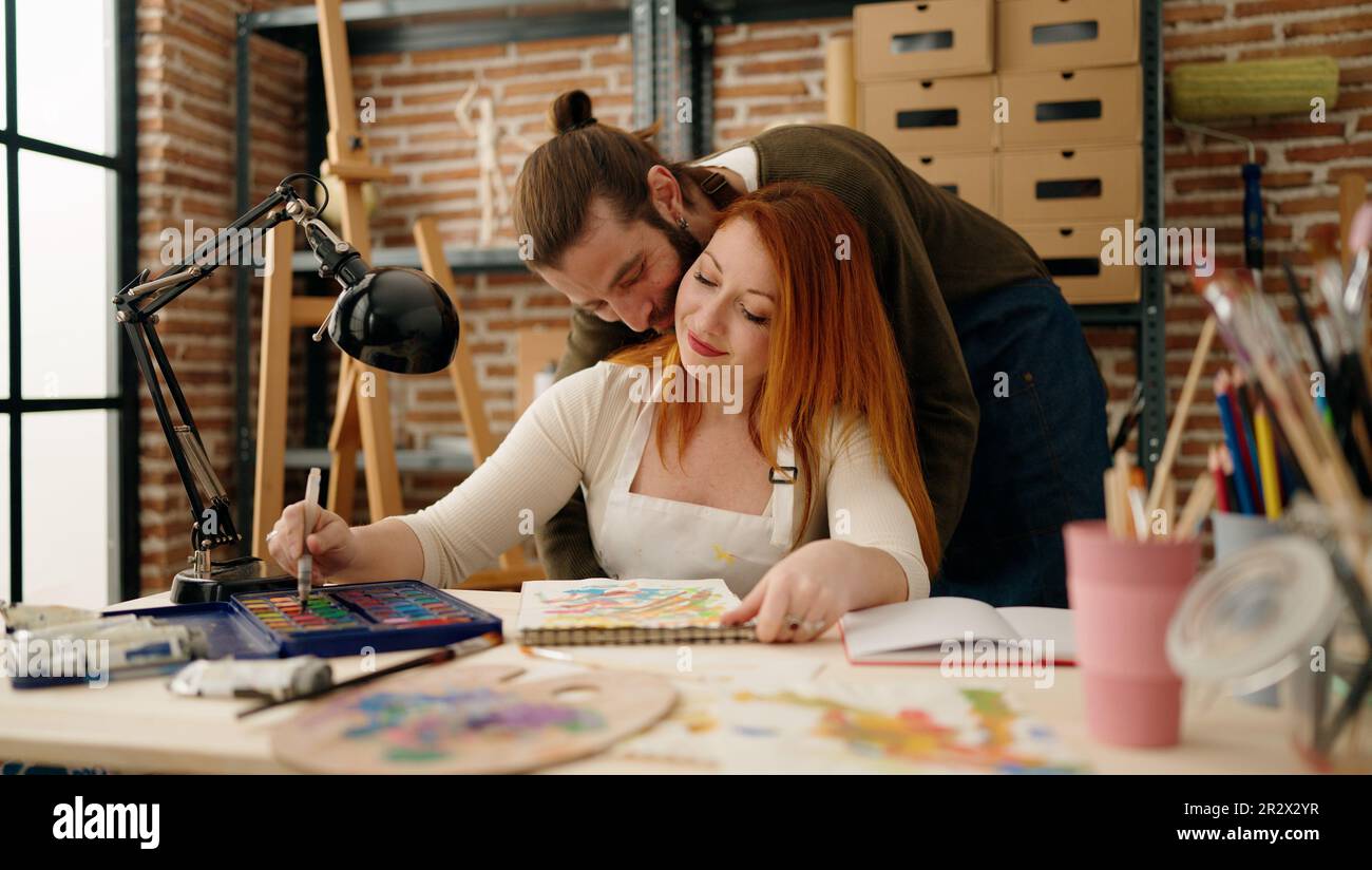 Man and woman couple smiling confident drawing at art studio Stock ...