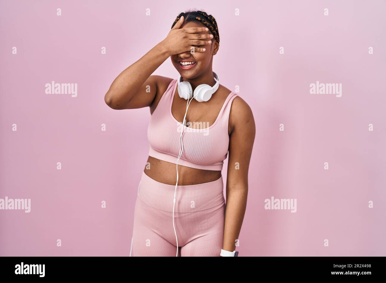 African american woman with braids wearing sportswear and headphones ...