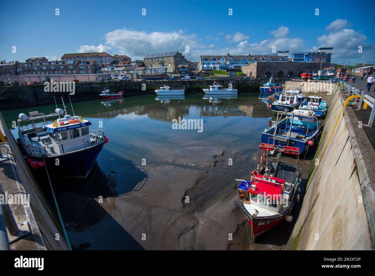The harbour at low tide at Seahouses on the north east coast of England ...