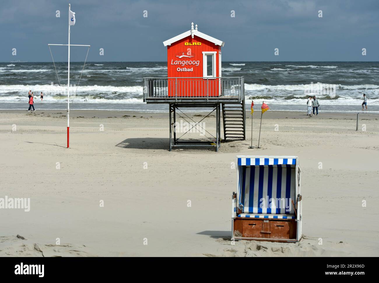 Empty beach chair and unmanned watchtower of the German Life Saving Society, Deutsche Lebens-Rettungs-Gesellschaft DLRG, on a cool and windy day in th Stock Photo
