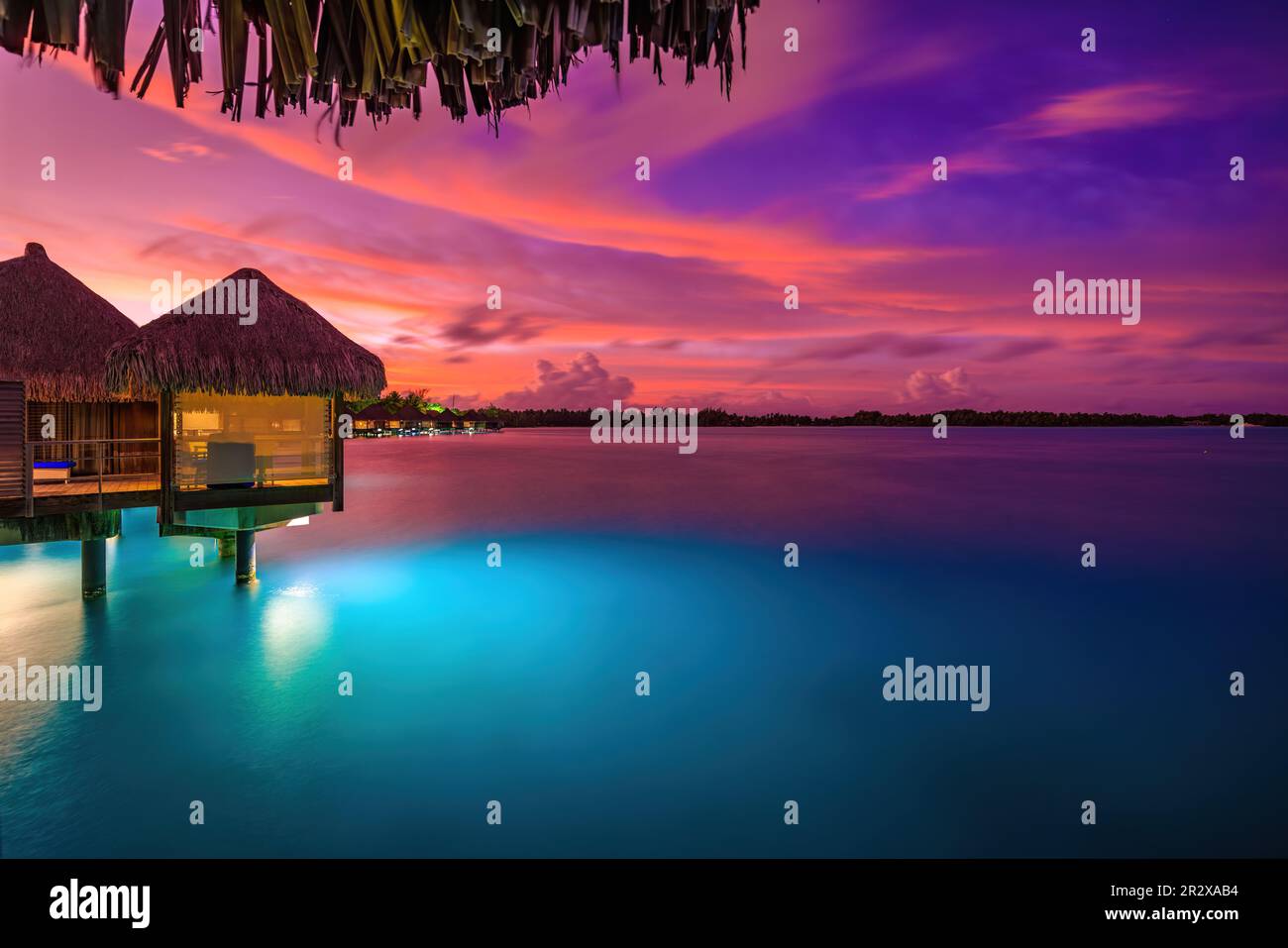 Beautiful sunrise color of overwater villa at The St. Regis Bora Bora Resort Stock Photo