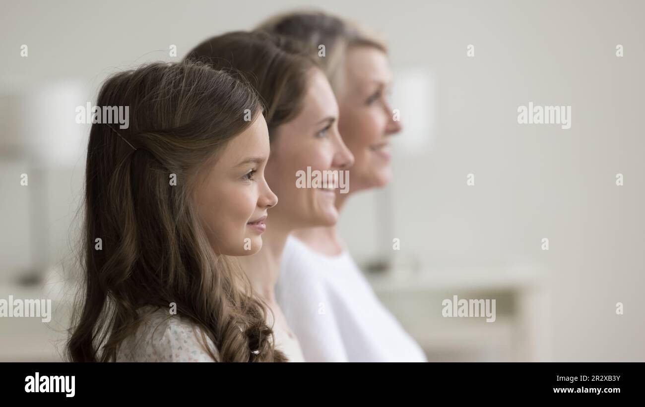 Happy three generation of women, side profile faces view Stock Photo