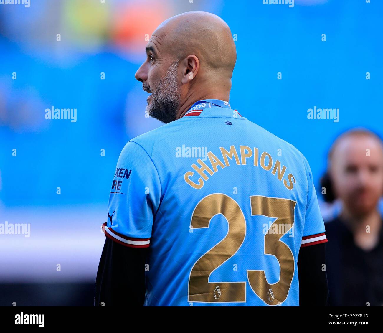 Pep Guardiola the Manchester City manager with his Champions 23 shirt after the Premier League match Manchester City vs Chelsea at Etihad Stadium, Manchester, United Kingdom, 21st May 2023 (Photo by Conor