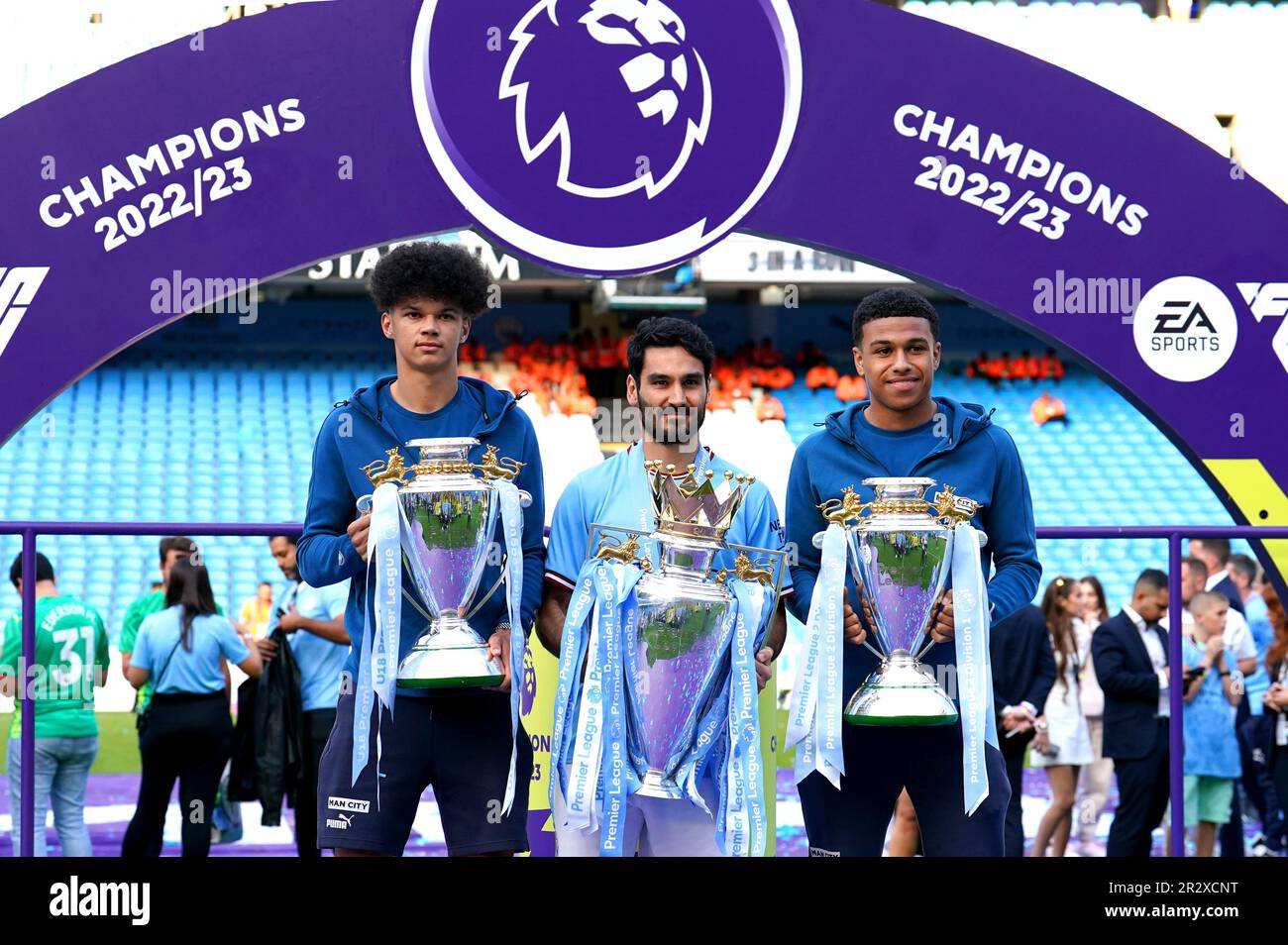 Manchester City's Ilkay Gundogan (centre), Manchester City U18 player Nico O'Reilly (left) and Manchester City EDS player Shea Charles (right) pose with the Premier League, U18 Premier League and Premier League Two, Division One trophies following the Premier League match at the Etihad Stadium, Manchester. Picture date: Sunday May 21, 2023. Stock Photo