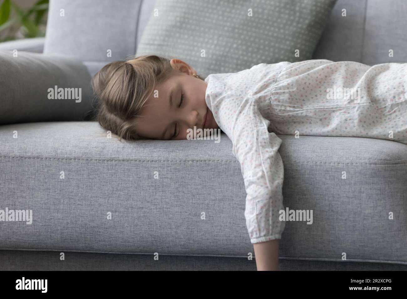 Child closed eyes lying on couch at home rest alone Stock Photo