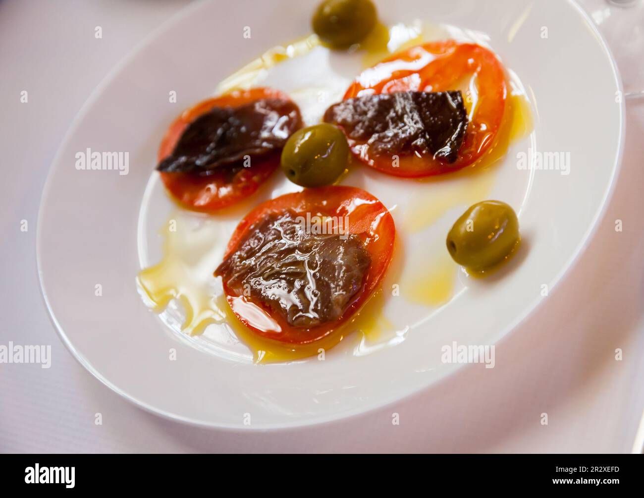 Sarda fish with sliced tomatoes Stock Photo