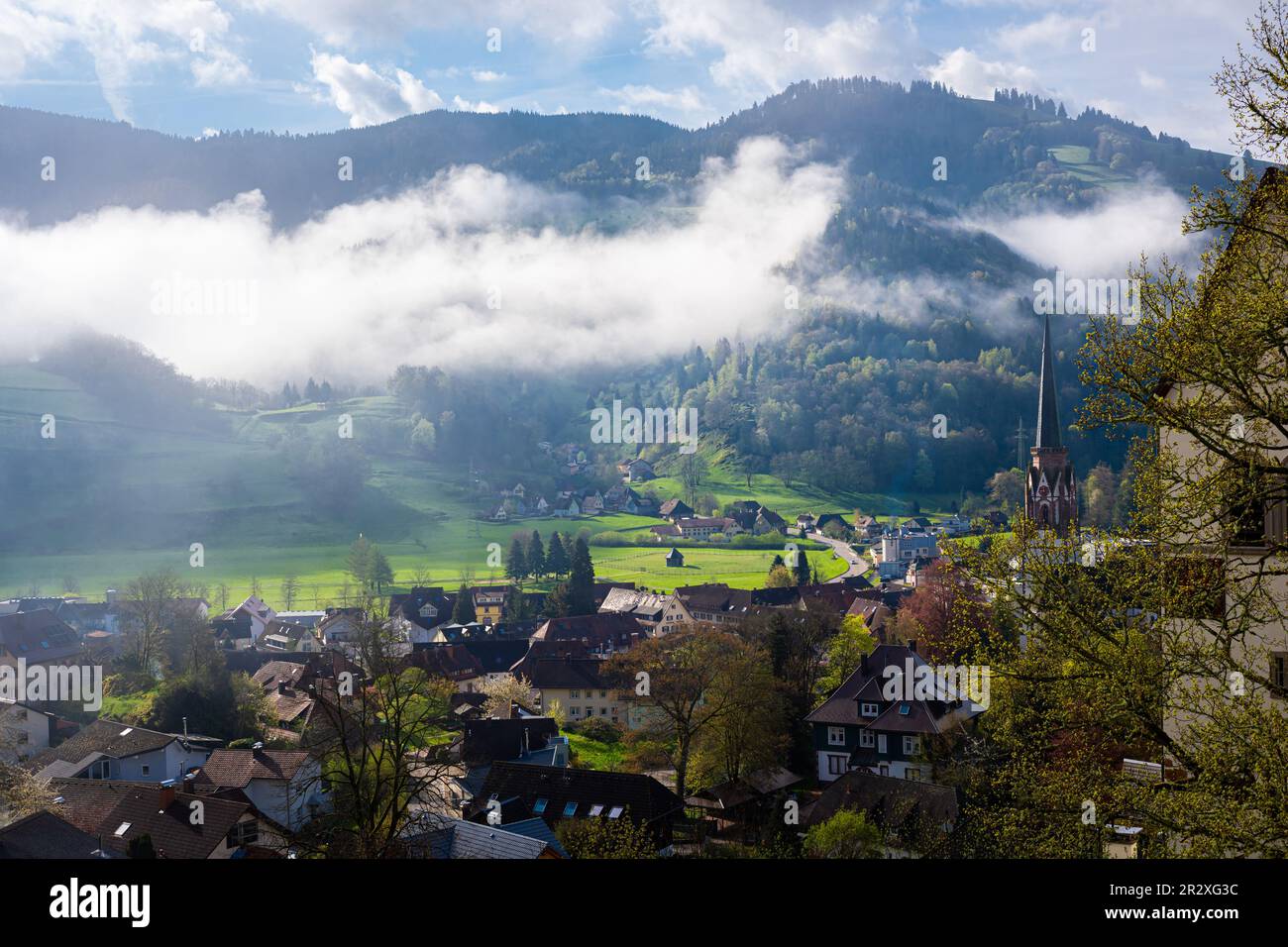 Dissolving clouds in a valley near Schönau im Schwarzwald in the Black Forest area, Germany in the morning Stock Photo