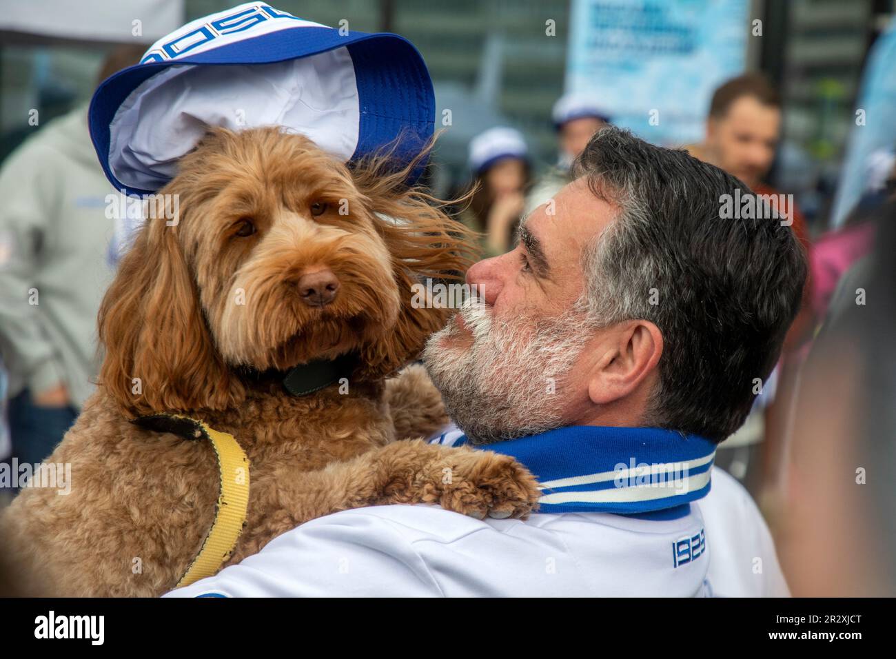 Moscow, Russia. 21st of May, 2023. Bosco di Ciliegi President Mikhail Kusnirovich poses with a dog before planting out wild cherry trees in Dynamo Park to mark the Dynamo Moscow centenary as part of the Cherry Forest Festiva, in Moscow, Russia Stock Photo