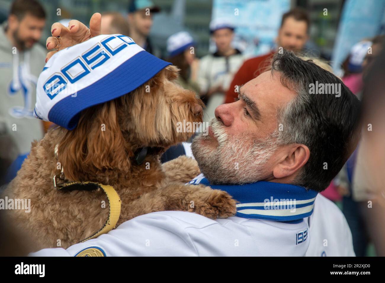 Moscow, Russia. 21st of May, 2023. Bosco di Ciliegi President Mikhail Kusnirovich poses with a dog before planting out wild cherry trees in Dynamo Park to mark the Dynamo Moscow centenary as part of the Cherry Forest Festiva, in Moscow, Russia Stock Photo