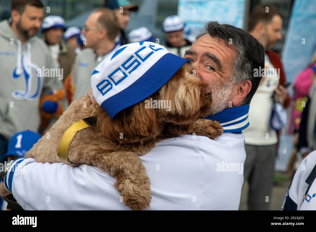 Moscow, Russia. 21st of May, 2023. Bosco di Ciliegi President Mikhail Kusnirovich poses with a dog before planting out wild cherry trees in Dynamo Park to mark the Dynamo Moscow centenary as part of the Cherry Forest Festiva, in Moscow, Russia Stock Photo