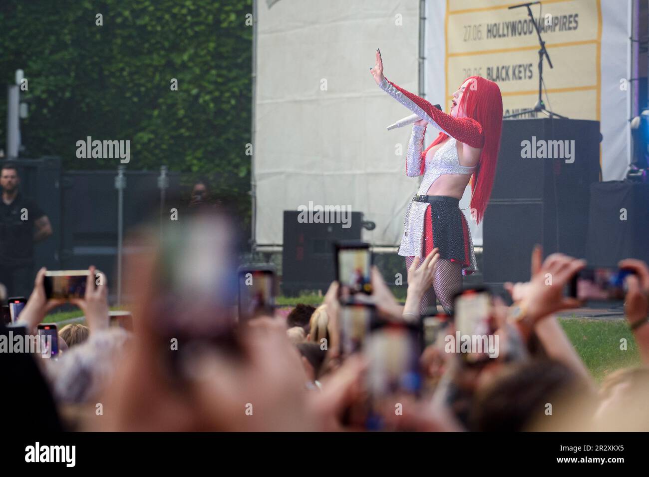 Hamburg, Germany. 21st May, 2023. Singer Ava Max sings into her microphone during one of two Germany concerts on stage at Hamburg's Stadtpark Open Air. Credit: Gregor Fischer/dpa/Alamy Live News Stock Photo
