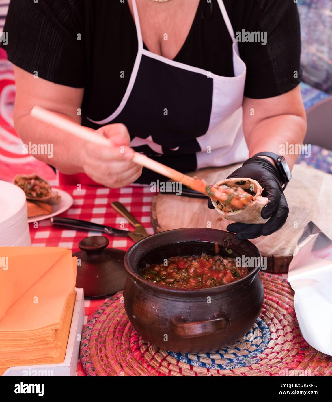 Woman making fresh whole wheat chicken empanadas at a food market in The Netherlands. Traditional Chilean savory pastry. Stock Photo