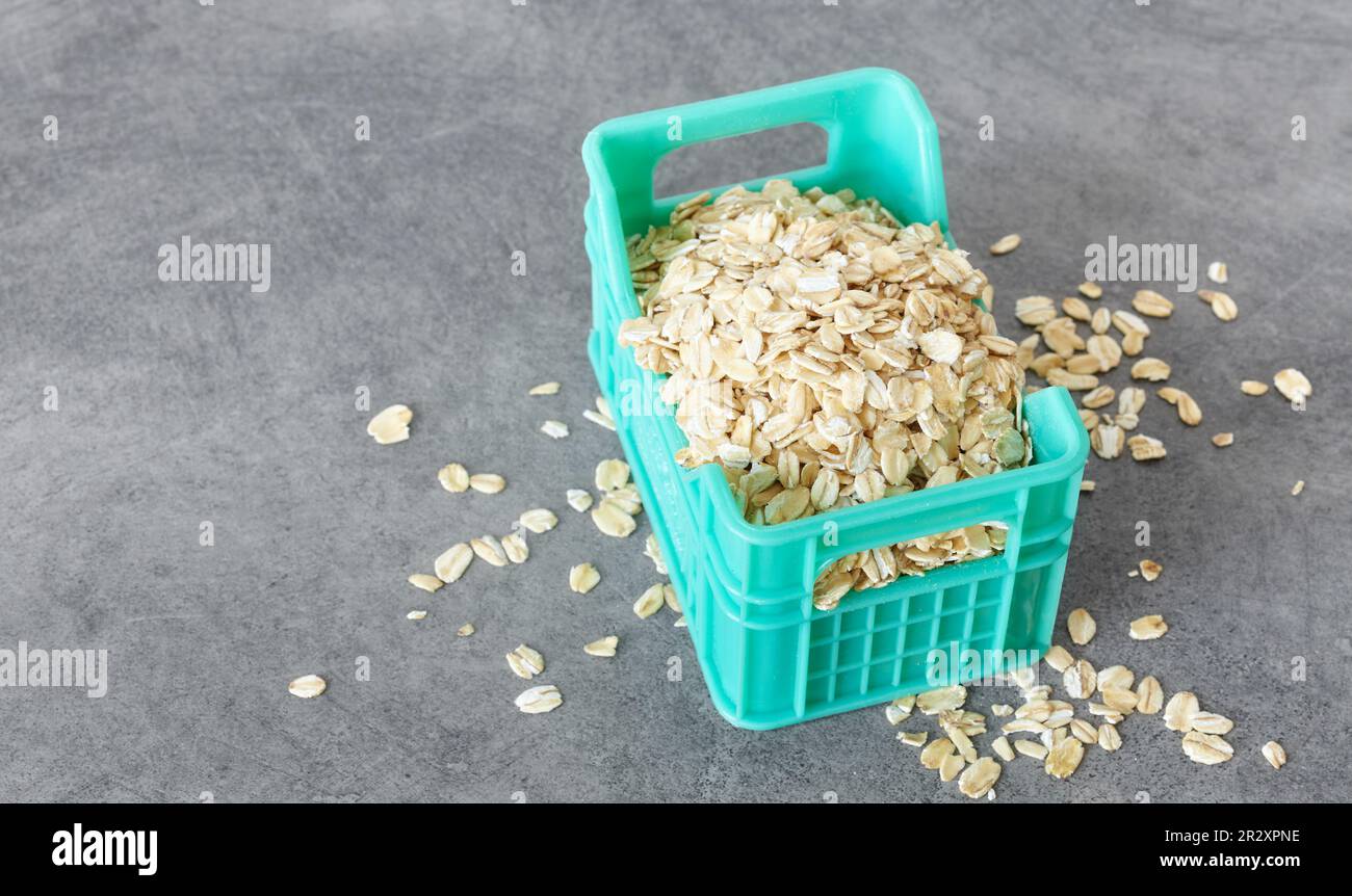 Close up picture of whole grain oats in miniature container, selective focus. Stock Photo