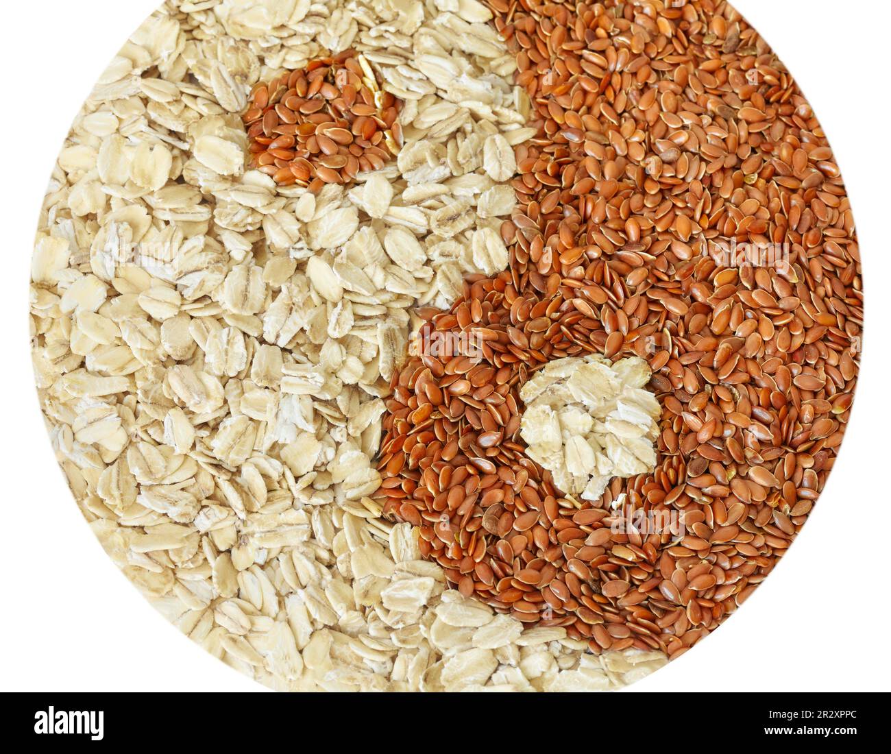 Yin and yang symbol made of flax seeds and whole grain oats isolated on white background. Stock Photo